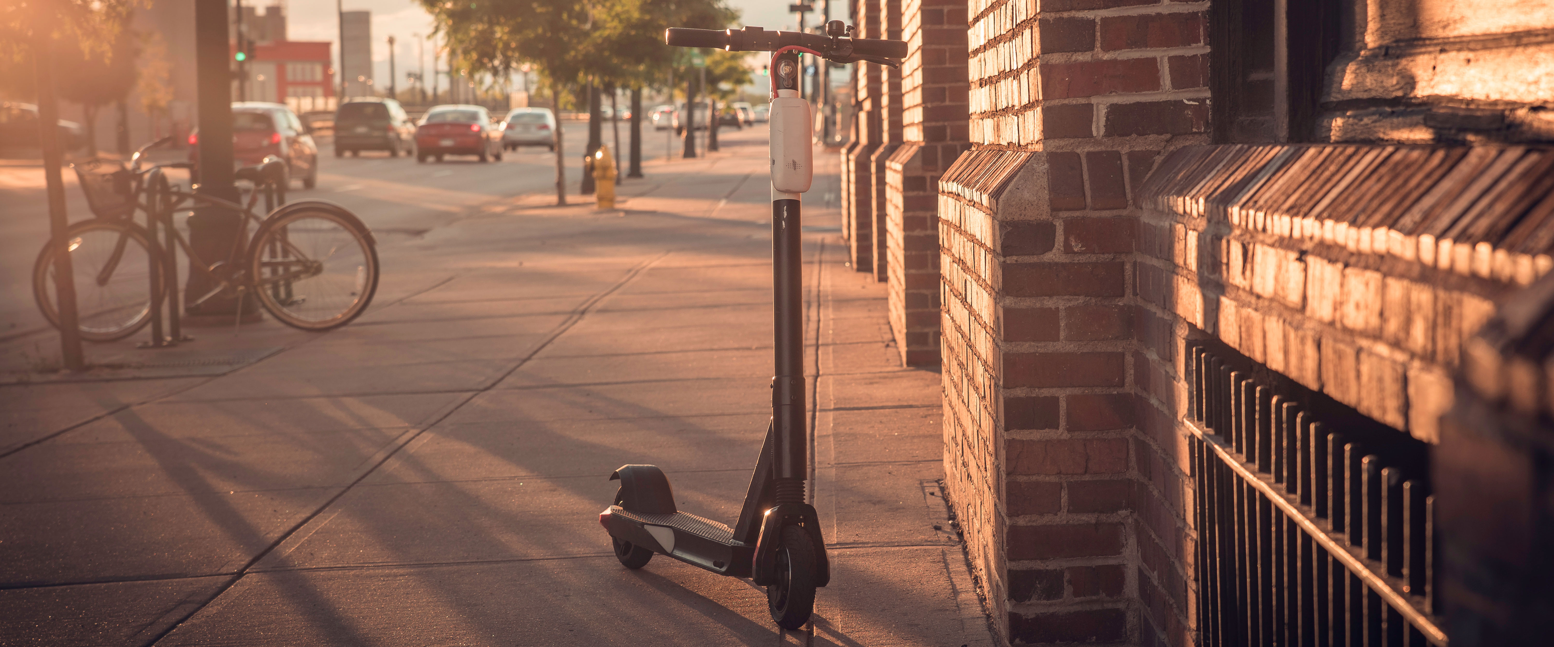 a scooter on a sidewalk of a city street